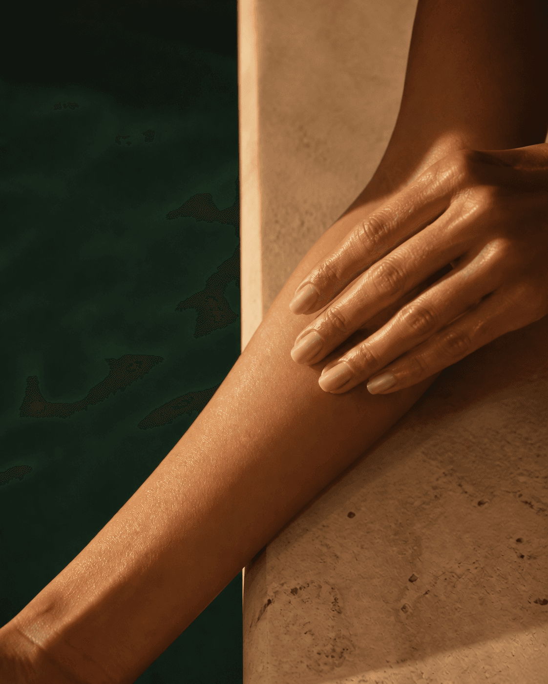 Hands pressing a subtle body-oil sheen into naturally textured skin